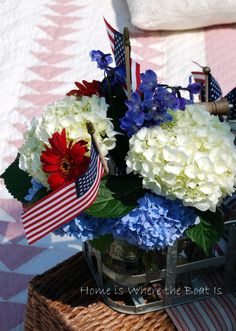 a basket with flowers and an american flag