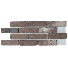 the back side of a brick wall with grey and white tiles on it's sides