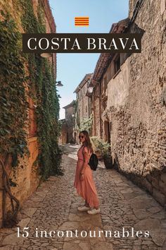 a woman walking down a cobblestone street in an old town with the caption costa brava 15 incontotarnables