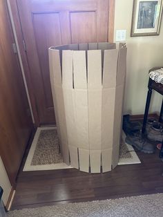 a cardboard box sitting on the floor in front of a door