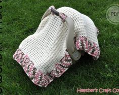 a crocheted blanket laying on the grass