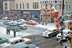 an old photo of cars and people in the snow