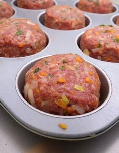 a muffin tin filled with meat and vegetables