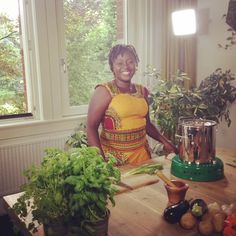 a woman standing in front of a table with vegetables