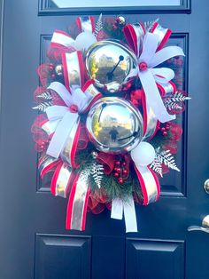 a christmas wreath on the front door with bells