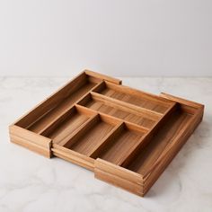 three wooden trays sitting on top of a marble counter