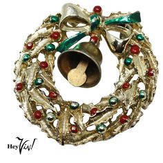 a christmas wreath with bells hanging from it