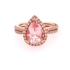 Pear shaped morganite (pink emerald) gemstone set in a diamond halo. The ring is a beautiful pink (rose) gold with diamonds going half way around the band. This ring has so much personality and spunk! 2.25ct Morganite Gemstone-Pink color 0.49ct Total Diamond Weight-SI1 clarity and H color (Very good quality) 14K Rose Gold Size 6.5 and can be ordered from size 5.5 to 9. Pink Topaz Ring With Halo Setting As Gift, Pink Morganite Halo Jewelry, Pink Diamond Halo Promise Ring, Pink Halo Ring Fine Jewelry, Pink Pear-shaped Diamond Ring, Pink Morganite Pear-shaped Jewelry, Pink Pear-shaped Morganite Jewelry, Pink Halo Ring In Fine Jewelry Style, Pink Morganite Jewelry With Halo Design