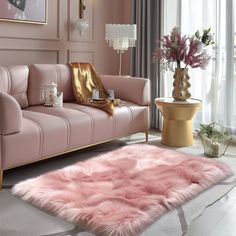 a living room with pink furniture and gold accents on the walls, flooring and rugs