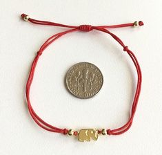 Gold plated over 925 sterling silver elephant red bracelet .adjustable .for protection ,good luck and prosperty. --comes with free gift pouche. pulsera rojo de plata esterlina 925 con baño de oro elefante buena suerte. ajustable. para dinero,buena suerte y prosperidad. --gratis bolsa de regalo. Gold Jewelry With Adjustable Cord For Good Luck, Red Bracelet, Silver Elephant, Elephant Bracelet, Silver Elephants, Red Bracelets, Cord Bracelets, Adjustable Bracelet, Alex And Ani Charm Bracelet