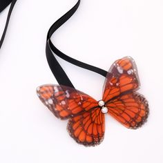 This handmade ribbon tie accessory is meticulously hand-crafted with precision and attention to details, capturing the likeness of a real butterfly. The voluminous silk butterfly, worn around your neck, frames the face and adds a touch of creativity to any outfit. It is sewn by hand to a high-quality silk satin ribbon tie with an adjustable length to suit various styles.  You can wear it around your neck as a choker, adorning your hair, around your wrist as a bracelet, or even around your waist Butterfly Ribbon, Silk Butterfly, Light Summer Dresses, Real Butterfly, Tie Hair, Black Choker Necklace, August Birthstone Jewelry, July Birthstone Jewelry, Jewelry Ring Box