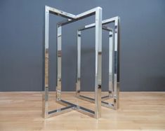 a metal sculpture sitting on top of a hard wood floor