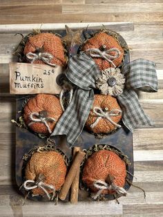 three pumpkins are wrapped in burlocks and tied up with twine bows