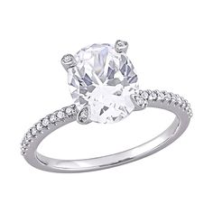 an oval cut diamond engagement ring with pave set shoulders