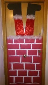 a door decorated to look like santa's stockings and feet are hanging on the brick wall