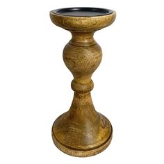 a wooden candle holder sitting on top of a table