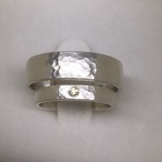 a silver ring with a diamond in the center on a white background, showing that it has been made to look like something out of metal