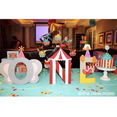 a circus themed birthday party with carnival decorations and paper cutout letters on the table