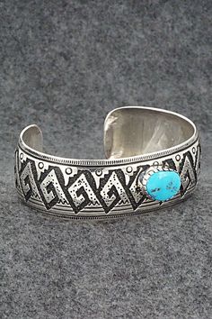 This beautiful turquoise and sterling silver bracelet was made by Navajo silversmith Richard Singer. The back is signed R Singer and stamped .925.Size: 6 7/8" (will fit up to a 8" wrist)Gap: 1 1/8"Width: 1"Free shipping on all orders! We ship with USPS and always include tracking. All orders ship within a day of payment.Returns are accepted up to 30 days after you receive your order. Just send us a message. Our shop offers cash back or store credit. The item must be returned in new condition. Traditional Turquoise Sterling Silver Cuff Bracelet, Adjustable Southwestern Sterling Silver Bracelet With Turquoise, Adjustable Southwestern Turquoise Sterling Silver Bracelet, Adjustable Turquoise Sterling Silver Bracelet In Southwestern Style, Stamped Turquoise Sterling Silver Bracelet, Stamped Sterling Silver Bracelet In Turquoise, Sterling Silver Turquoise Stamped Bracelet, Southwestern Style Stamped Turquoise Bracelets, Southwestern Style Turquoise Stamped Bracelets