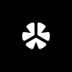 a black and white logo with the letter k on it's left side, in front of a dark background