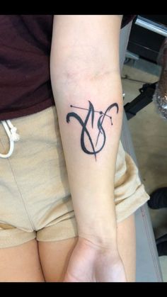 a woman's arm with a tattoo on it that has the letter y in black ink