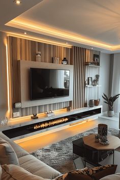 a living room with white furniture and a flat screen tv mounted on the wall above it