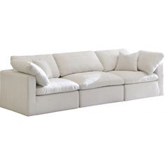 a large white couch with pillows on it's back and arms, sitting against a white background