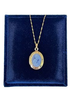 Genuine blue carved agate Mother-Child cameo locket necklace. A gift any Mother will love-a sweet, genuine cameo carved from agate. The pendant is a neoclassical woman and child against a blue background. This is the real thing - carved from agate stone, and is framed in a 14k yellow gold oval locket setting that opens to hold two photos. The locket comes on a new 14k- 18 inch chain. ERA - Circa 2019 METAL / MATERIAL - 14k Yellow Gold, Agate, 14k gold chain  MARKING / HISTORY - Locket is marked Victorian Cameo Locket Necklace As A Gift, Classic Cameo Necklace For Gift, Classic Cameo Necklace As Gift, Elegant Oval Cameo Locket Necklace, Victorian Oval Necklace Keepsake, Oval Blue Locket Necklace, Victorian Oval Necklace For Keepsake, Blue Oval Locket Necklace, Victorian Oval Keepsake Necklace