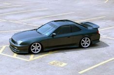 a black sports car parked in a parking lot