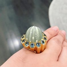 This John Hardy ring is glamorous to wear! With an alluring 38 carat moonstone in the center, surrounded by beautiful blue stones. All set in 18k yellow gold. Ring is preowned. Ring size is a 6 and weighs 40 grams. Luxury Hallmarked Moonstone Ring Fine Jewelry, Luxury Polished Moonstone Ring In 14k Gold, Luxury Gold Moonstone Collectible Ring, Luxury Multi-stone Gold Moonstone Ring, Luxury Blue Multi-stone Moonstone Ring, John Hardy Rings, Blue Stones, John Hardy, Aquamarine Ring