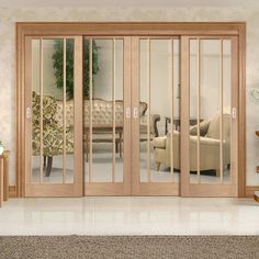 a living room filled with furniture and glass doors