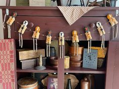 an old wooden cabinet with lots of items on it and some magnets attached to the doors