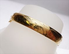 "If you are looking for a beautiful and expertly made solid bangle bracelet, than this is the one for you! This is a gorgeous piece, all hand made with fabulous detail! The bracelet is a 9.5mm wide solid bangle made of 14 karat yellow gold. It measures just under 2mm thick so it will not dent easily. The top of the bangle has a hand engraved design in a paisley type pattern. The etching really stands out against the high polish of the bracelet. It secures with a tongue and groove clasp that is a Diamond Wedding Sets, Bangles Making, Hand Engraving, Diamond Wedding, Are You The One, Bangle Bracelets, Cuff Bracelets, Paisley, Jewelry Bracelets