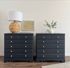 two black dressers with gold handles and drawers