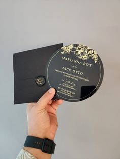 a person holding up a black and gold card with the words, marinana boy on it