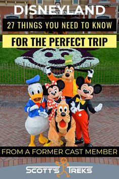 mickey and friends posing for a photo in front of the disney land sign with text that reads