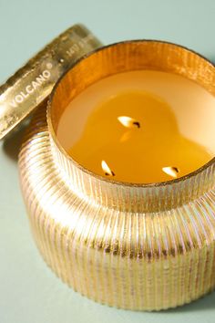 a gold colored cup with a candle inside