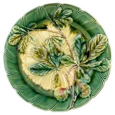 a green and yellow plate with leaves on it