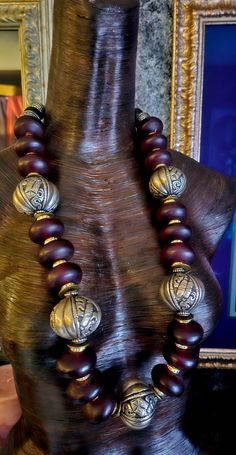 Rare and Scarce beads abound in this lightweight, 34" Moroccan Burgundy Resin and Tibetan Silver Fancy Repousse Tribal Statement Rope. Each bead is separated by a gold aurora borealis rhinestone rondelle. Iris Apfel Inspired. The back is finished with tribal silver tone stamped bi-cones, round black onyx, tribal spacers and ornate bi-cones. Fastens with a fancy hook and eye. Unisex styled. Great worn alone or as a layering piece. From KatKouture. Rocker Chic Accessories, Unique Pendant Necklace, Long Statement Necklace, Statement Bib Necklace, Elephant Head, Mermaid Necklace, Neck Piece, Statement Pendant, Black Feathers