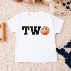 Basketball Birthday Shirt, Second Birthday Shirt, Boy Birthday Shirt, Basketball Birthday, Birthday Boy Shirt, Toddler Birthday Shirt 💗  Welcome to The WildflowerbyMiley Etsy Shop!  This listing is for the bodysuit, sweatshirt or t-shirt only. All other items that are shown in our photos such as shoes, hats, beanies, blankets etc. are for photo staging purposes and are NOT INCLUDED in the sale. DESCRIPTION:  This baby and children's unisex essential fits like a well-loved favorite. Super soft t Personalized White Tops For Birthday, Number Print Crew Neck Shirt For Birthday, Personalized Graphic Tee For Birthdays, Birthday Number Print Graphic Tee, Crew Neck Shirt With Number Print For Birthday, Number Print Short Sleeve Top For First Birthday, Casual Personalized Shirt For Birthday, Birthday Gift Number Print Short Sleeve Top, White Number Print Top For Birthday