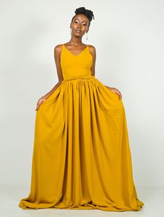 Long, elegant, and stunning, Hornet is the dress you want to be wearing when you show up to that summer event. You will turn heads. Oh! You will turn heads. In fact, you might even break a few necks (poor necks 😊) It is made from polyester fabric. It features a Vneck at the front and a Criss-cross rope pattern at the back. You can request a closed back in the Personalization text box below. The dress has pockets on both sides. The dress is 64 inches long. The length can be adjusted on request. The model is wearing a UK 6/XS. She is 5'6/ 168 cm. Colour: Mustard Mustard Wedding Dresses, Outfit Palette, Mustard Yellow Dress, Fashion Costume Halloween, Mustard Dress, Mehndi Outfits, Mustard Yellow Dresses, Rope Pattern, African Wear Dresses