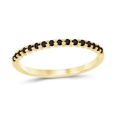 a yellow gold ring with black stones