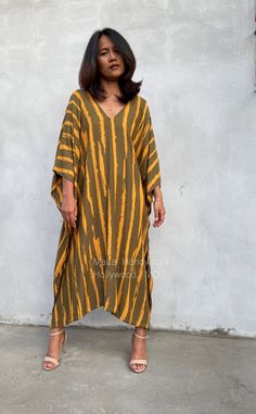 This kaftan complements all body types with its long, loose design and slits up both sides. The unique pattern is created by using a discharge dye process to remove color. I use a high quality rayon fabric that both flows and drapes around you. The eco printed kaftan can be worn in many stylish ways to make you look your best. DETAIL * All measurements are flat * Bust/ Waist/ Hips 34 in (Circumference 68 in.) * Arms 11 in. (Circumference 22 in.) * Length 42 in. * V-Neck * Side slits * No pocket Striped Long Sleeve Summer Kaftan, Casual Long One-size Kaftan, Yellow Printed Beachwear Kaftan, Casual Yellow V-neck Kaftan, Casual Striped V-neck Kaftan, Black Kaftan, One Shoulder Prom Dress, Dalian, Cotton Kaftan