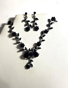 "Beautiful Black Crystal Rose Necklace & Earrings Set , Black Metal Flowers Jewelry Set  Beautiful Necklace is 15 1/2 \" and the black crystal drop is 2\" long. The earrings are almost 1 1/2 \" long. Black crystals are in the Roses and leaves and in the center of 2 Pear shaped black crystals and then leaves with black crystals and a black crystal Rose and the end. Earrings have a black crystal stud and a black crystal Rose flower and black crystal leaves. Please ask question as I do not accept r Black Homecoming Jewelry, Prom Jewelry Black Dress, Black Prom Necklace, Black Accesorios, Black Sparkly Jewelry, Black Elegant Necklace, Black Bridal Jewelry, Black Prom Accessories, Cute Black Necklace