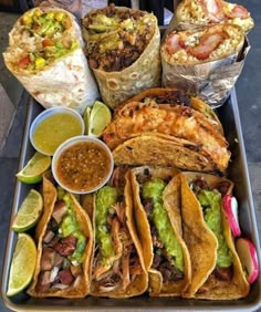 a tray filled with tacos and other foods