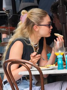 a woman sitting at a table eating food