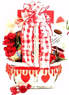 a basket filled with lots of red and white items on top of a table next to candy