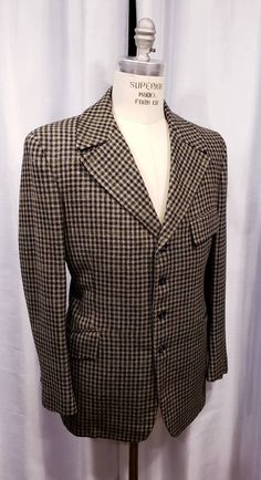 Beautiful houndstooth cloth two piece suit probably made in the 70's but exceptional quality. With the proper accessories it would be hard to tell this is not a true period piece, but the next best thing. Ready for the Dickens Faire or a period holiday party. Inside label reads: Mike Bain Inside pocket still has the Amalgamated Union Tag made in the USA the United States of America. Coat measures: Shoulders 18 1/2 inches, Chest 45 inches, sleeves 25 inches and length is 31 inches. Pants measure: Black Houndstooth Tweed Jacket For Formal Occasions, Semi-formal Tweed Jacket With Houndstooth Pattern And Suit Collar, Semi-formal Houndstooth Tweed Jacket With Suit Collar, Semi-formal Tweed Jacket With Houndstooth Pattern, Semi-formal Houndstooth Tweed Jacket, Fitted Vintage Outerwear With Houndstooth Pattern, Vintage Houndstooth Outerwear With Notch Lapel, Vintage Fitted Houndstooth Blazer, Fitted Vintage Houndstooth Blazer