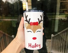 a hand holding a starbucks cup with reindeer on it and the words haley written in red