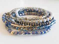 "Monochromatic bracelet stacks, made up of high-quality czech glass beads and semi-precious gemstones! This blue stack contains a semi-precious sodalite bracelet. Purchase an individual bracelet, or choose \"Entire Stack\" from the drop-down to receive one of each. The bracelets have been designed to look great on their own, and they stack beautifully with any of the bracelets in our shop!  All the bracelets in the stack are a dainty 4mm size-- the faceted glass beads hit the light and create sp Natural Gemstone Jewelry Stretch Bracelets, Diy Stacking Bracelets, Stacked Crystal Bracelets, Blue Bracelet Stack, How To Make Stretchy Beaded Bracelets, Stretch Beaded Bracelets Diy, Monochromatic Blue, Sodalite Bracelet, Sundance Jewelry